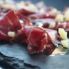 Whole 1 kg piece of Spanish Cecina, showcasing its deep red cured beef texture.