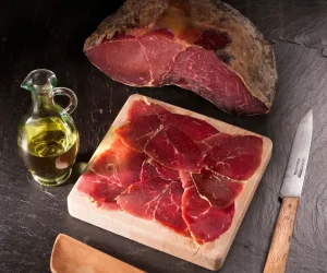 Whole 1 kg piece of Spanish Cecina, showcasing its deep red cured beef texture.